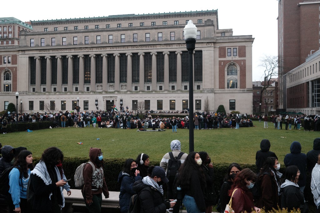 Hundreds of students gather on the lawn in front of Butler Library
